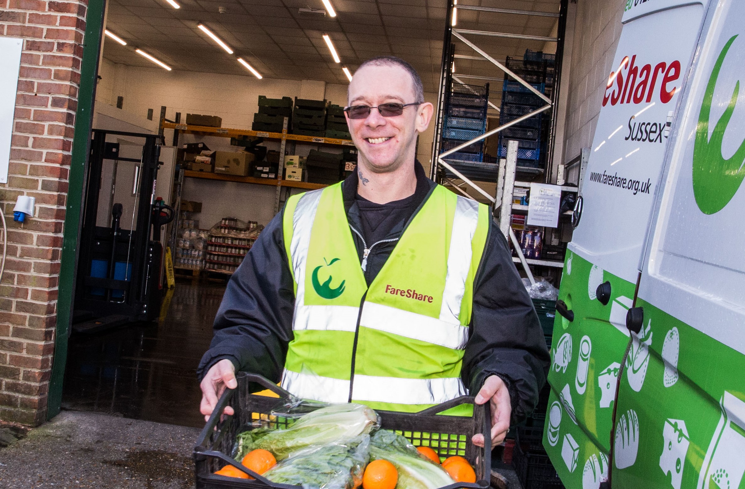 FareShare image with man carrying food donations